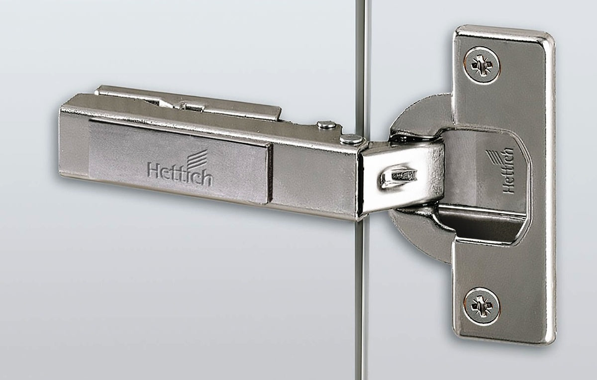 Charnière Hettich Intermat 110° 48049, schéma de perçage 52 x 5,5 mm avec plaque de montage en forme de croix. Charnière de meuble Intermat 9943, pour porte standard (porte en bois), porte à cadre en bois, porte à cadre en aluminium, à visser, par Hettich
